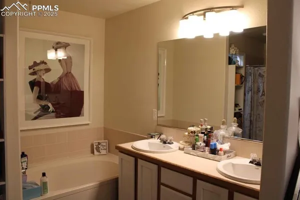 a bathroom with a sink double vanity and a mirror