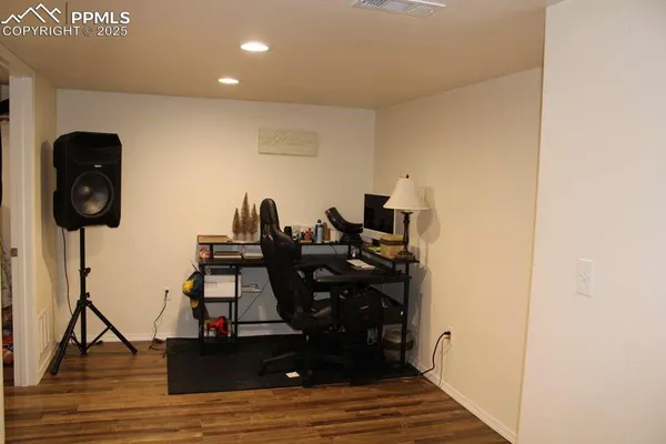 a view of a workspace with wooden floor