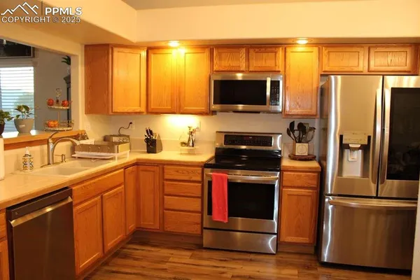 a kitchen with stainless steel appliances a stove microwave and a sink