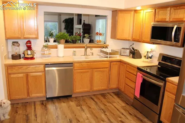 a kitchen with a sink stove and cabinets