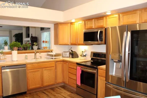 a kitchen with a sink stove and refrigerator