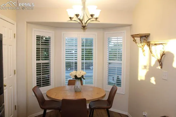 a view of a dining room with furniture and window