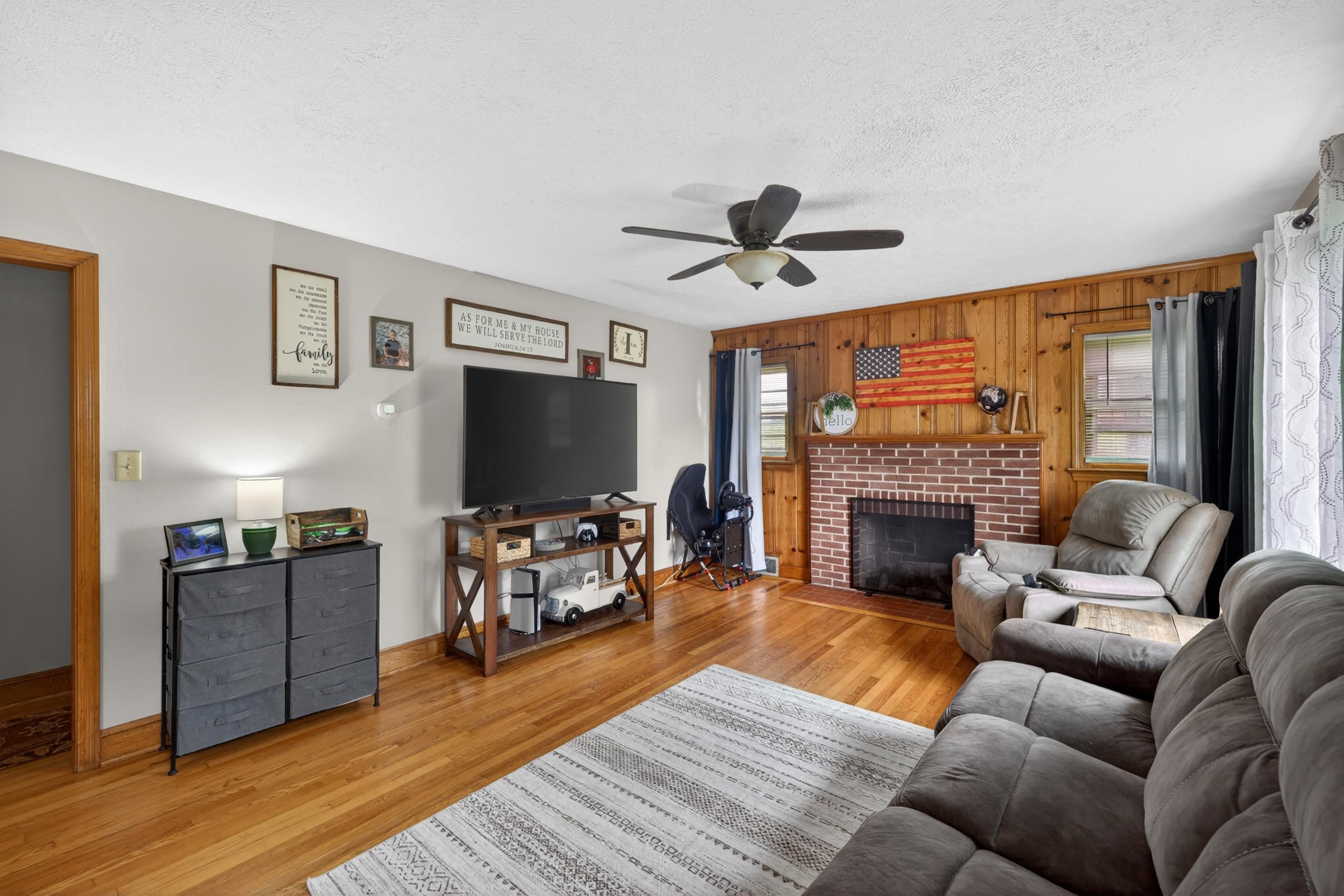 7827 Lee Highway Raphine, VA 24472 - Photo 13 of 62 a living room with furniture a flat screen tv and a fireplace