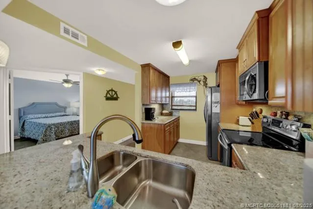 a kitchen with a sink appliances and cabinets