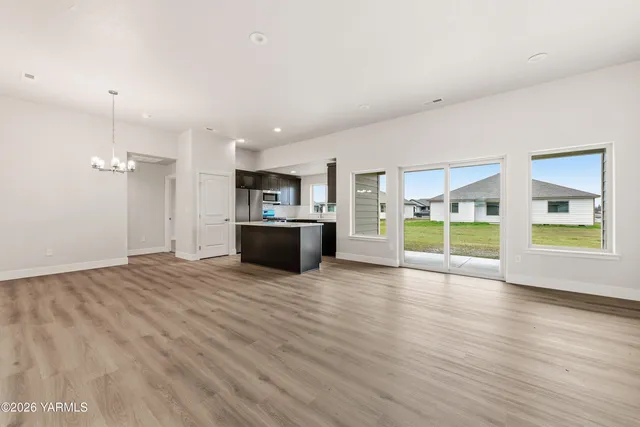 a kitchen with stainless steel appliances granite countertop a sink and a refrigerator