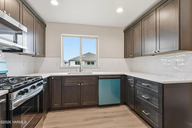 a kitchen with a refrigerator and a sink