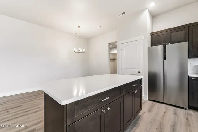 a large kitchen with stainless steel appliances a large counter top