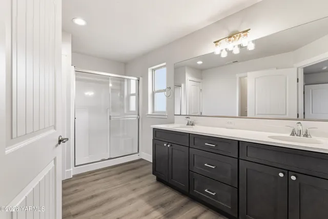 a spacious bathroom with a double vanity sink mirror and double
