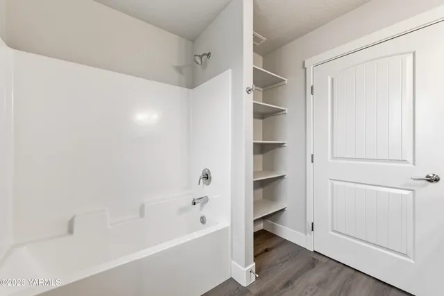 a view of kitchen with refrigerator microwave and wooden floor