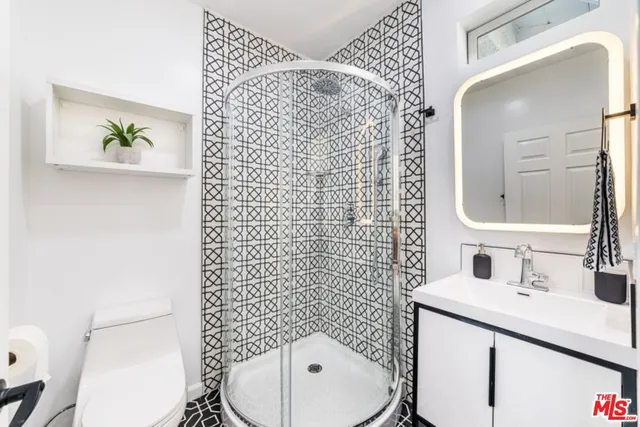 a bathroom with a sink mirror and toilet