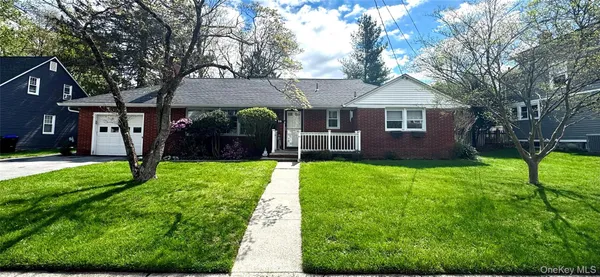 a view of house with a yard