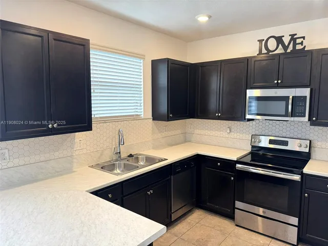 a kitchen with a sink and a microwave