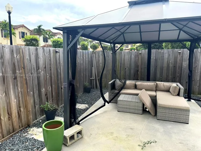 a backyard of a house with barbeque oven table and chairs