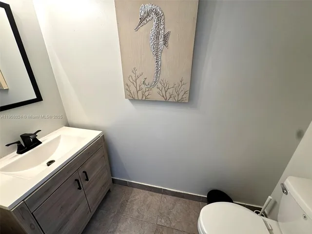 a bathroom with a toilet sink and vanity