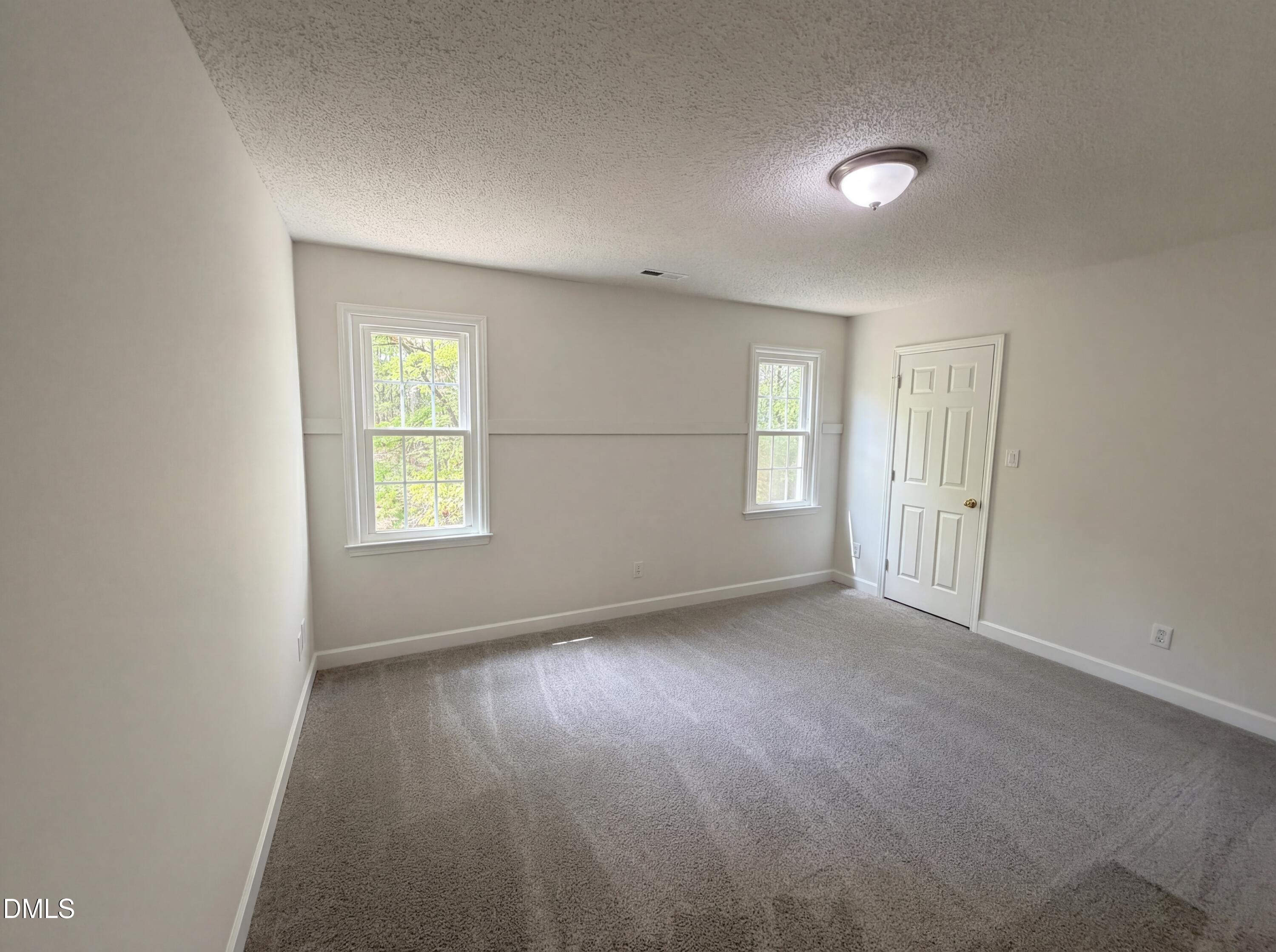 515 Gablefield Lane Apex, NC 27502 - Photo 12 of 20 an empty room with windows and closet