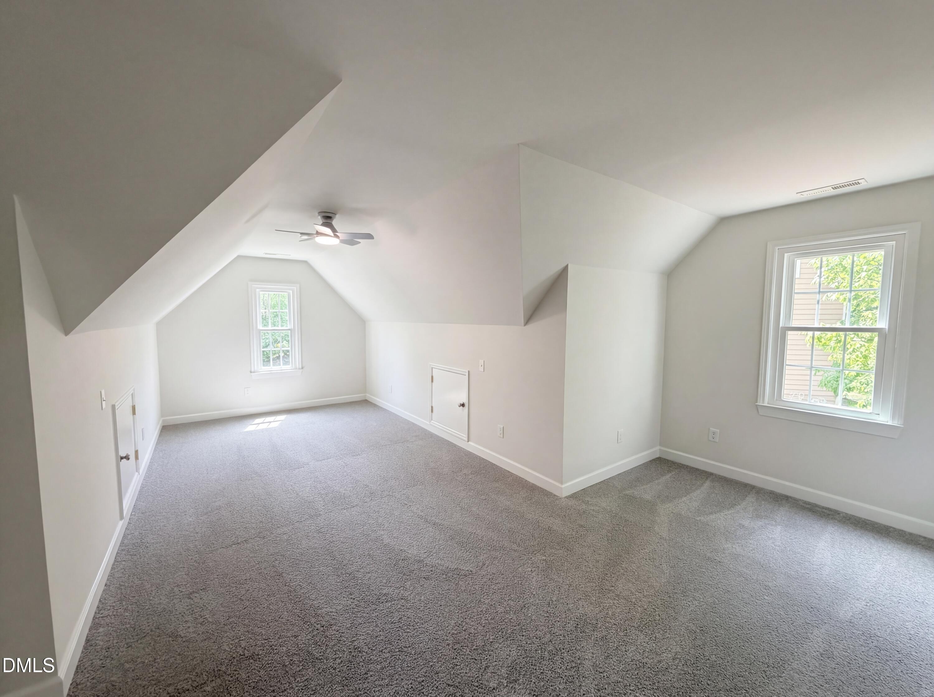 515 Gablefield Lane Apex, NC 27502 - Photo 15 of 20 a view of a big room with windows and chandelier fan