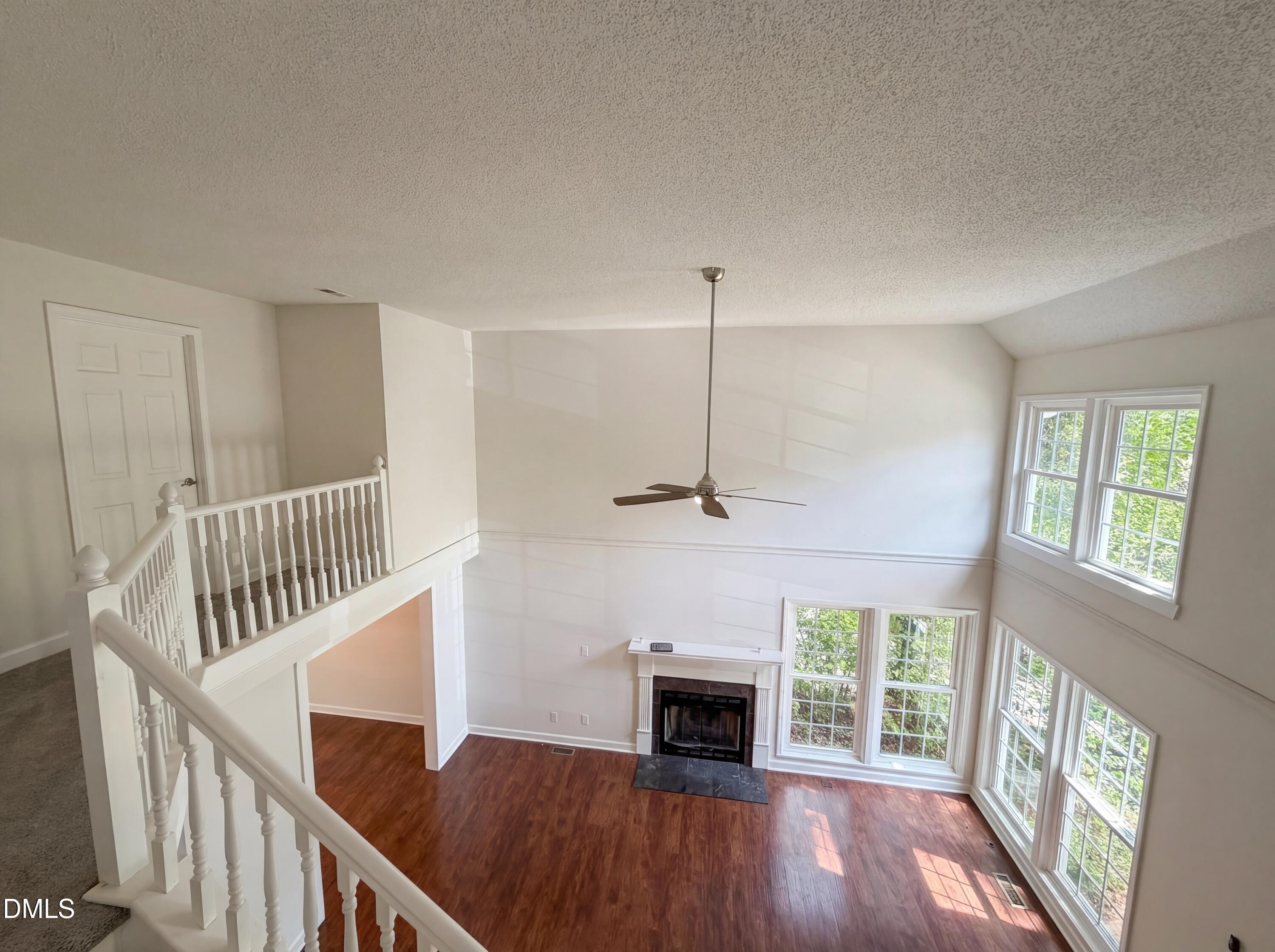 515 Gablefield Lane Apex, NC 27502 - Photo 4 of 20 a view of an empty room with wooden floor fireplace and a window