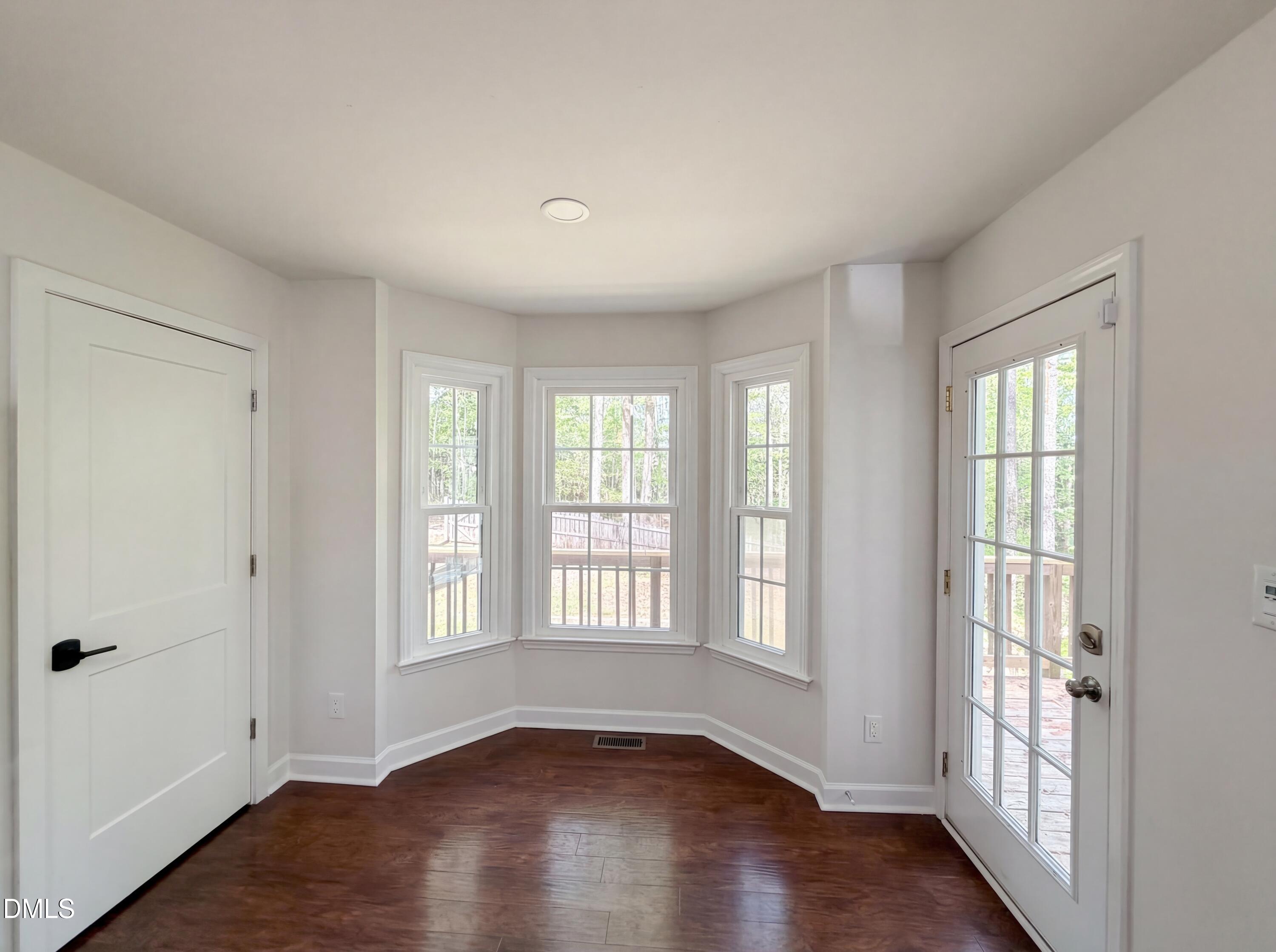 515 Gablefield Lane Apex, NC 27502 - Photo 6 of 20 a view of an empty room with wooden floor and a window