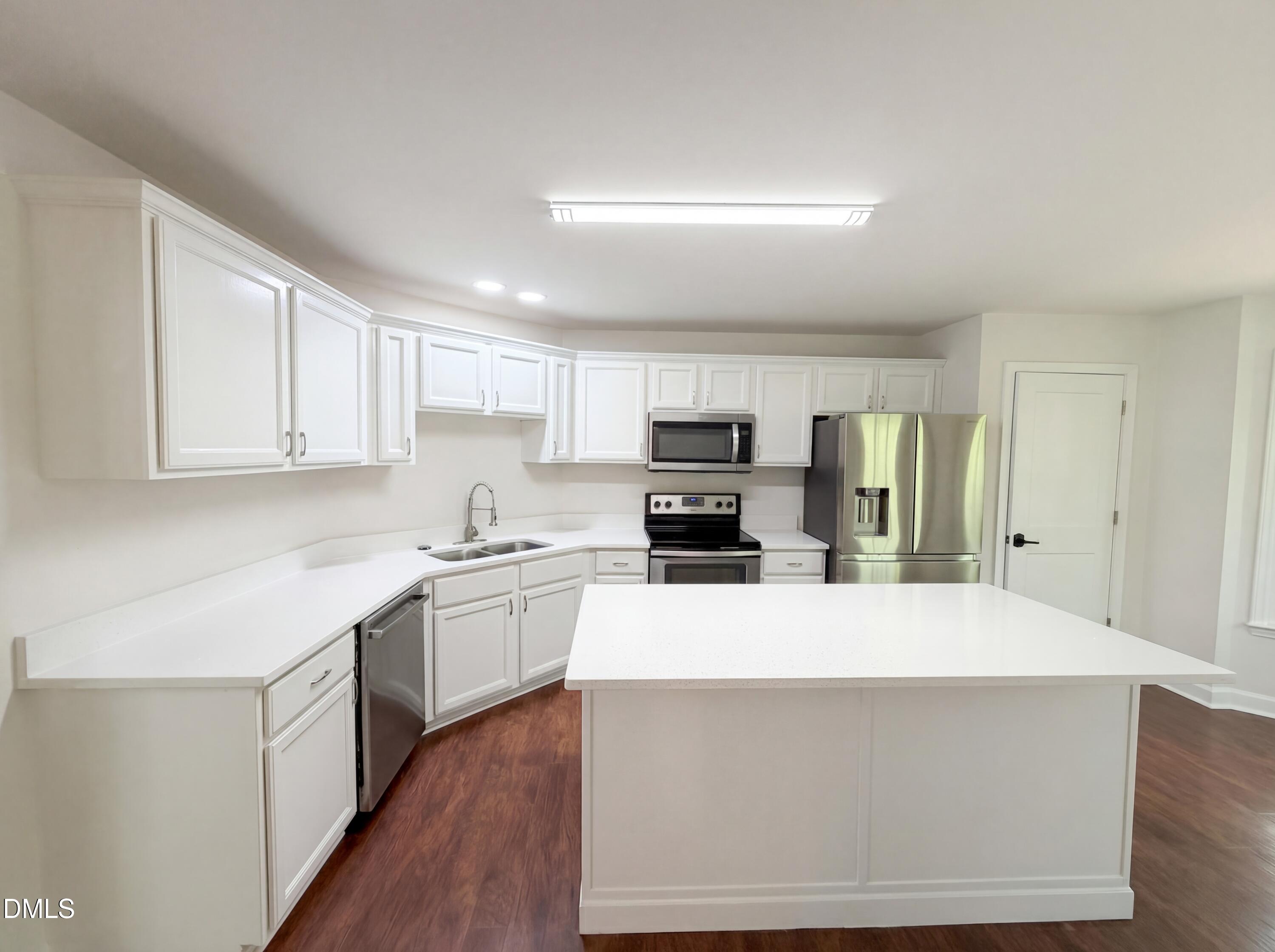 515 Gablefield Lane Apex, NC 27502 - Photo 8 of 20 a large kitchen with stainless steel appliances kitchen island a sink a stove a refrigerator a center island and cabinets