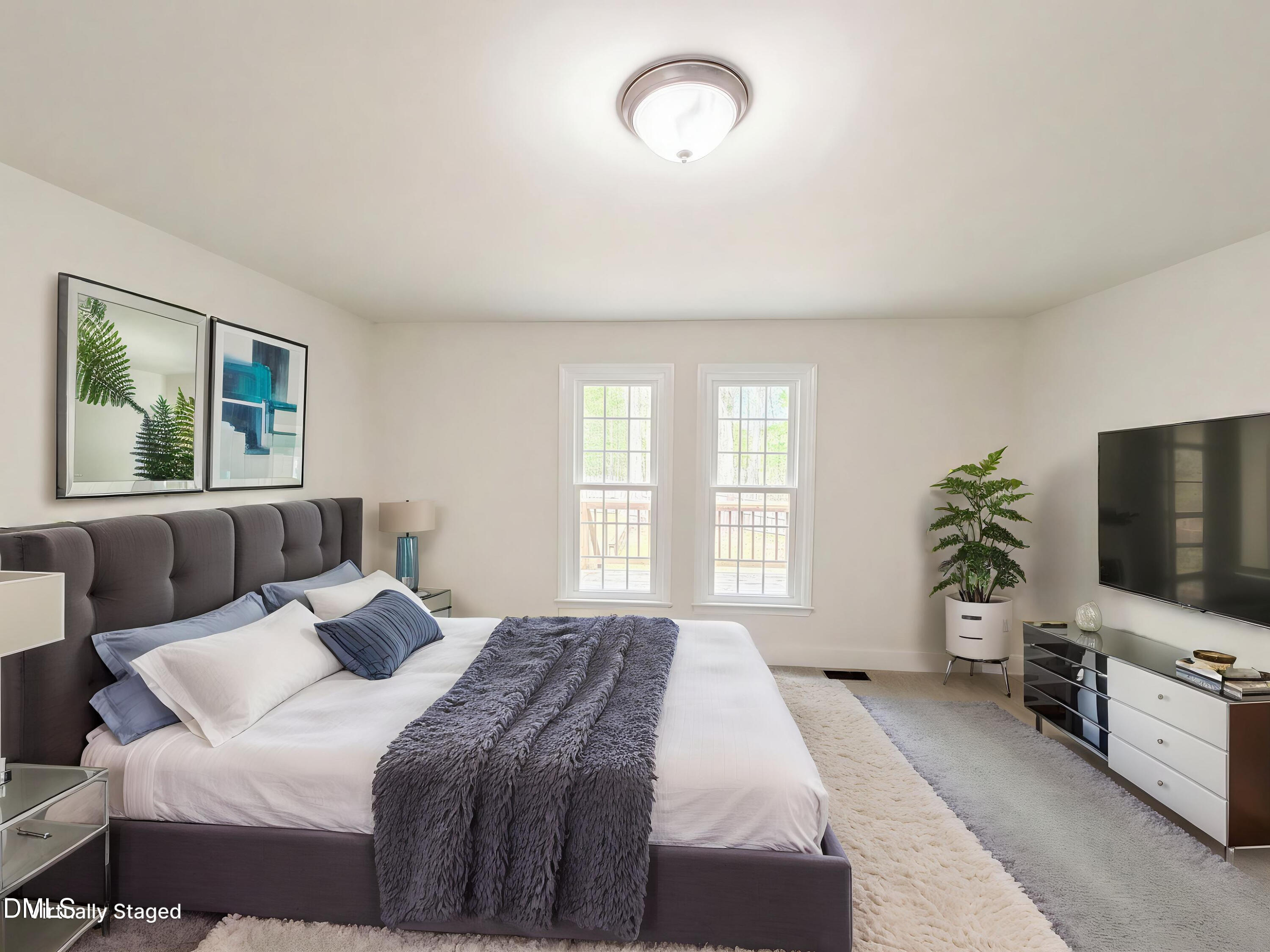 515 Gablefield Lane Apex, NC 27502 - Photo 10 of 20 a bedroom with a bed and a flat screen tv