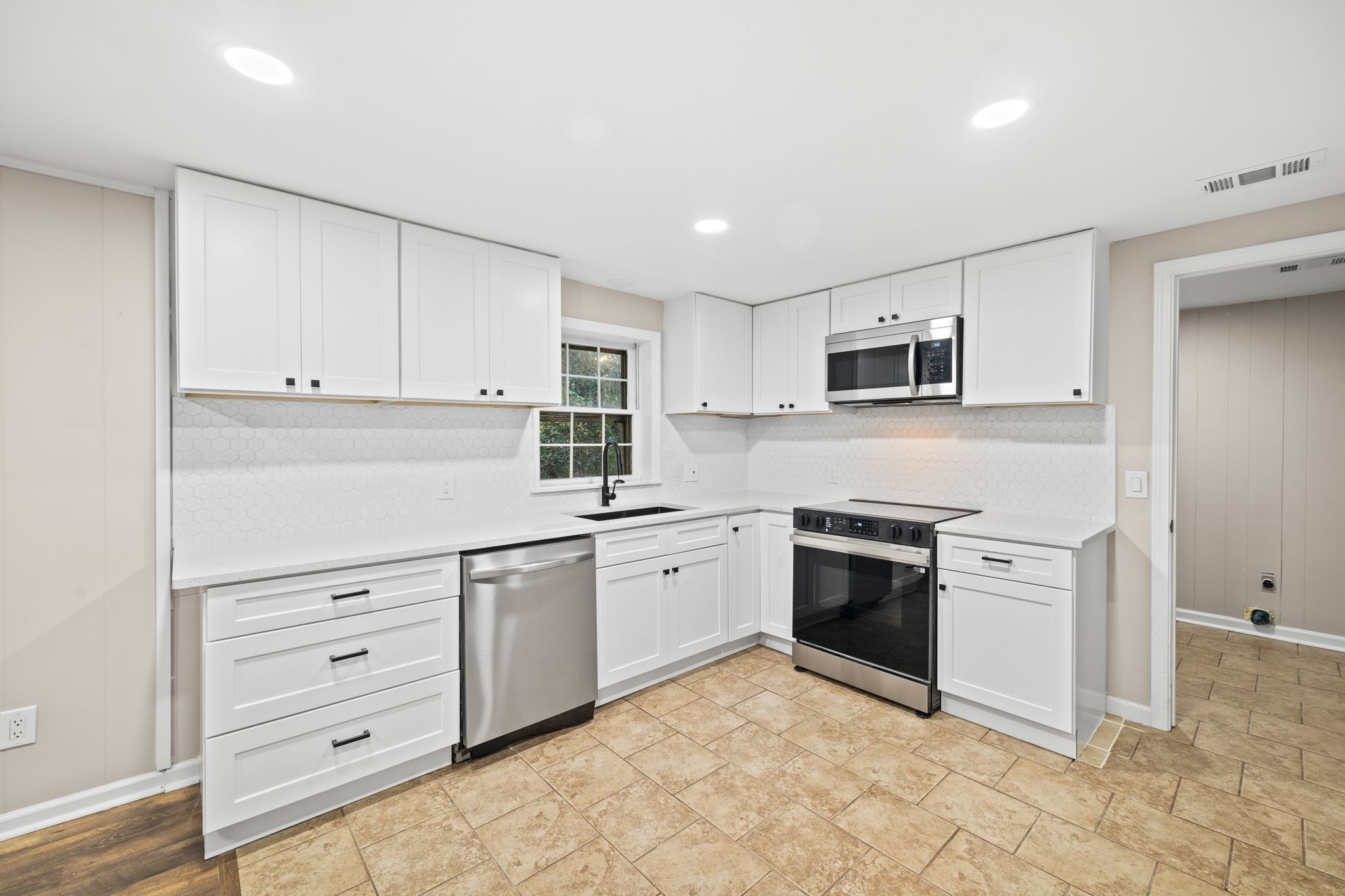 133 Mockerson Road Leoma, TN 38468 - Photo 12 of 33 a kitchen with granite countertop white cabinets and stainless steel appliances