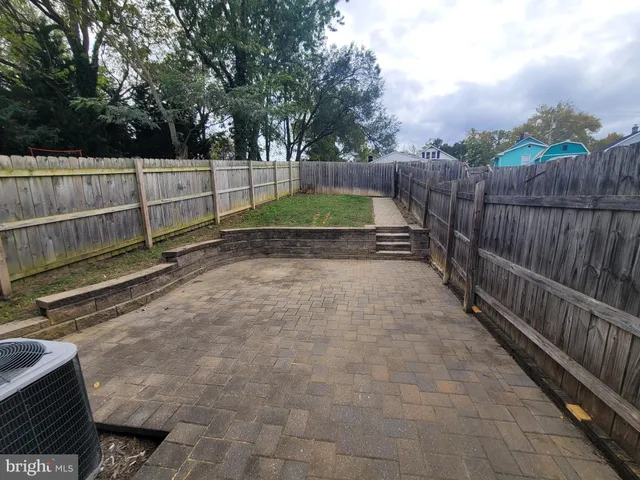 a view of a backyard with wooden fence