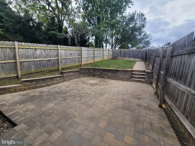 a view of backyard with wooden fence