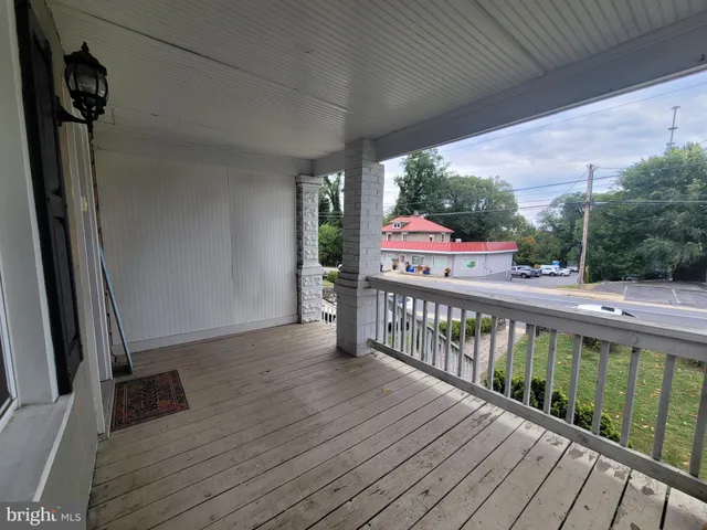 a view of a balcony with wooden floor