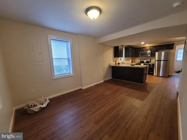 a kitchen with a wooden floor and window