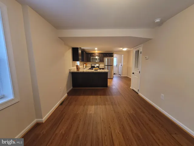 a view of a hallway with wooden floor