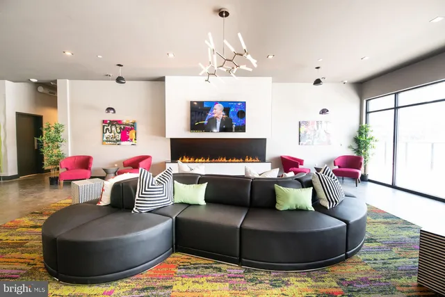 a living room with furniture and a chandelier