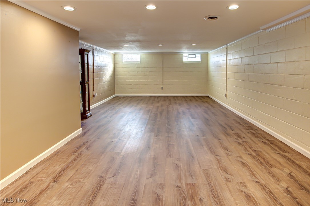 4234 Grafton Road Brunswick, OH 44212 - Photo 25 of 40 Family room featuring ornamental molding, hardwood / wood-style floors, and a fireplace