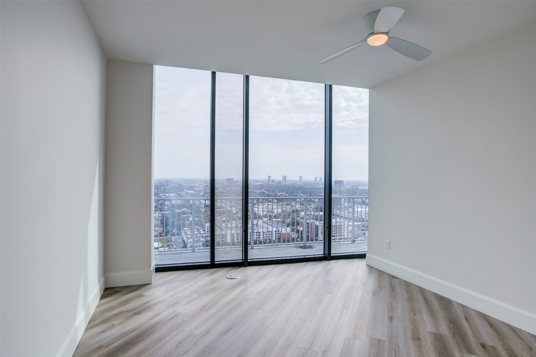 3333 Lake Street, Unit TH5 Houston, TX 77098 - Photo 40 of 50 an empty room with wooden floor and windows