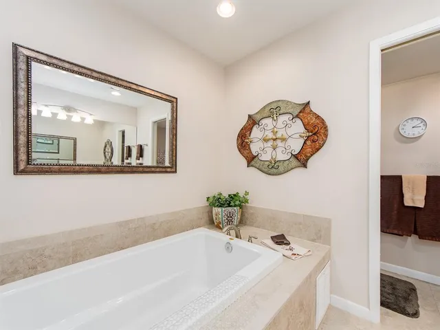 a bathroom with a bathtub and a window