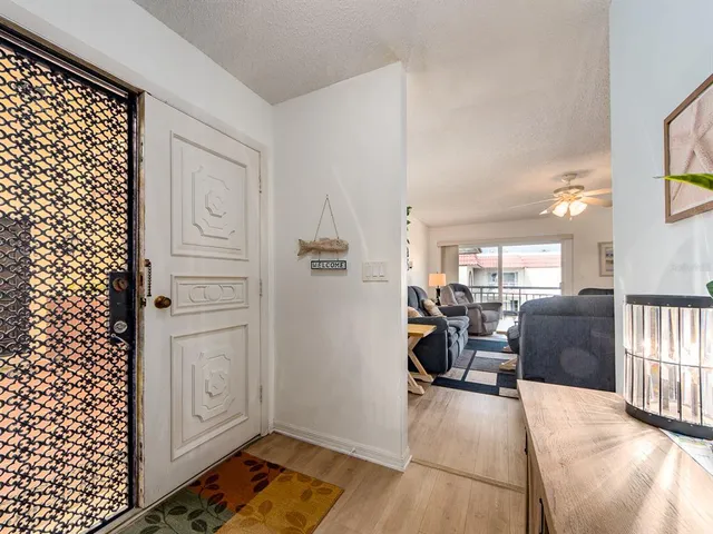a view of a livingroom with furniture wooden floor and windows