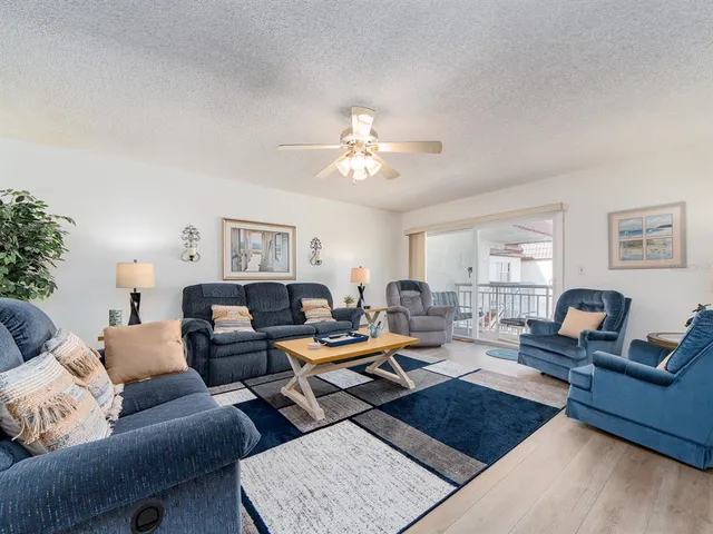 a living room with furniture a table and a window