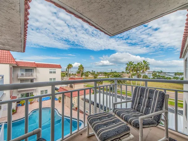 a view of a balcony with furniture