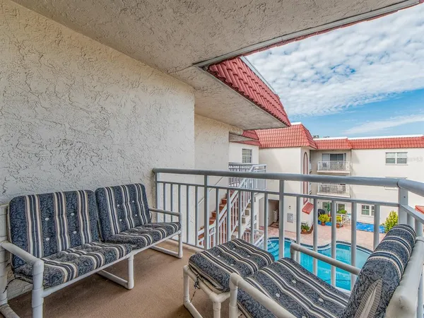 a view of a balcony with furniture