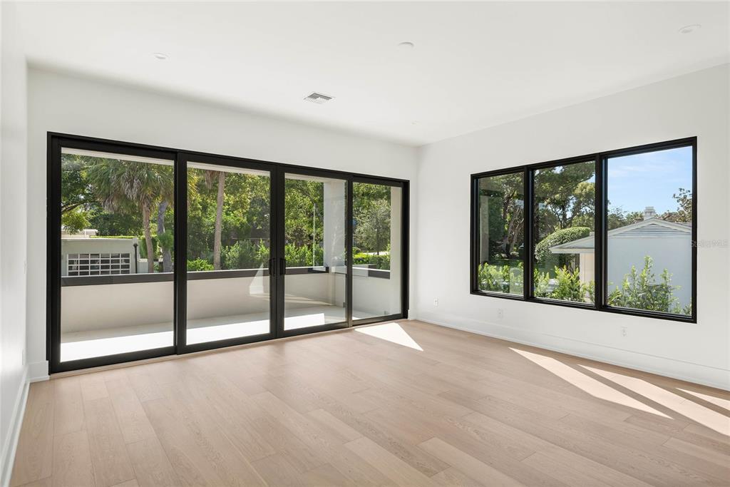 1821 Englewood Road Winter Park, FL 32789 - Photo 22 of 36 a view of an empty room with wooden floor and a window
