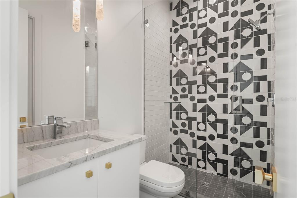 1821 Englewood Road Winter Park, FL 32789 - Photo 27 of 36 a bathroom with a granite countertop sink toilet and shower