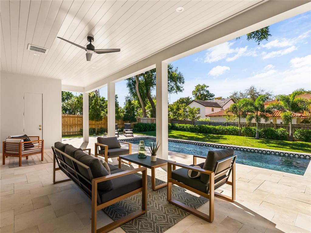1821 Englewood Road Winter Park, FL 32789 - Photo 31 of 36 a living room with patio furniture and a floor to ceiling window