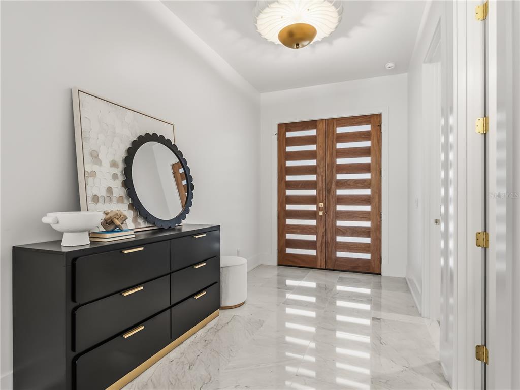 1821 Englewood Road Winter Park, FL 32789 - Photo 4 of 36 a living room with a mirror and a dresser with mirror