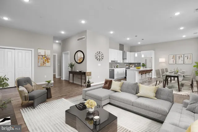 a living room with furniture kitchen view and a table