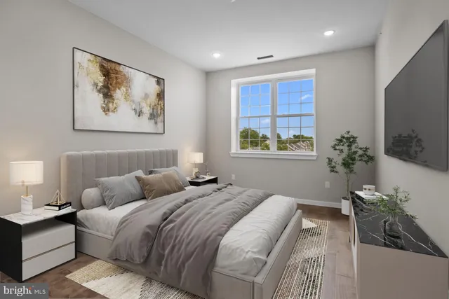 a bedroom with bed and a potted plant