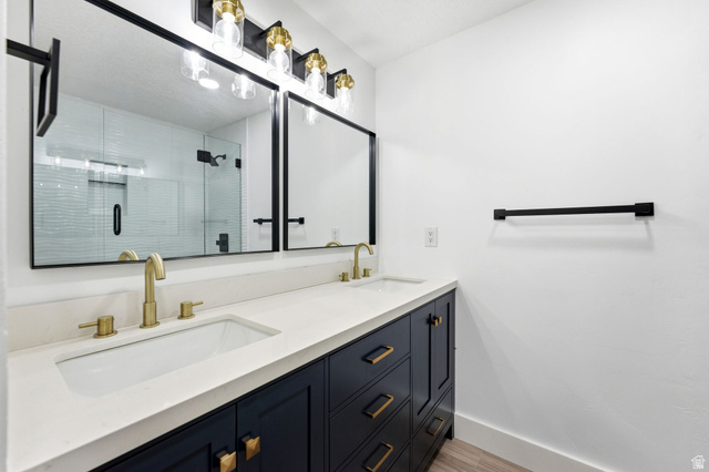 871 Bonita Way Centerville, UT 84014 - Photo 18 of 61 Dual vanity with white countertop, undermount sinks, and brass-finish fixtures