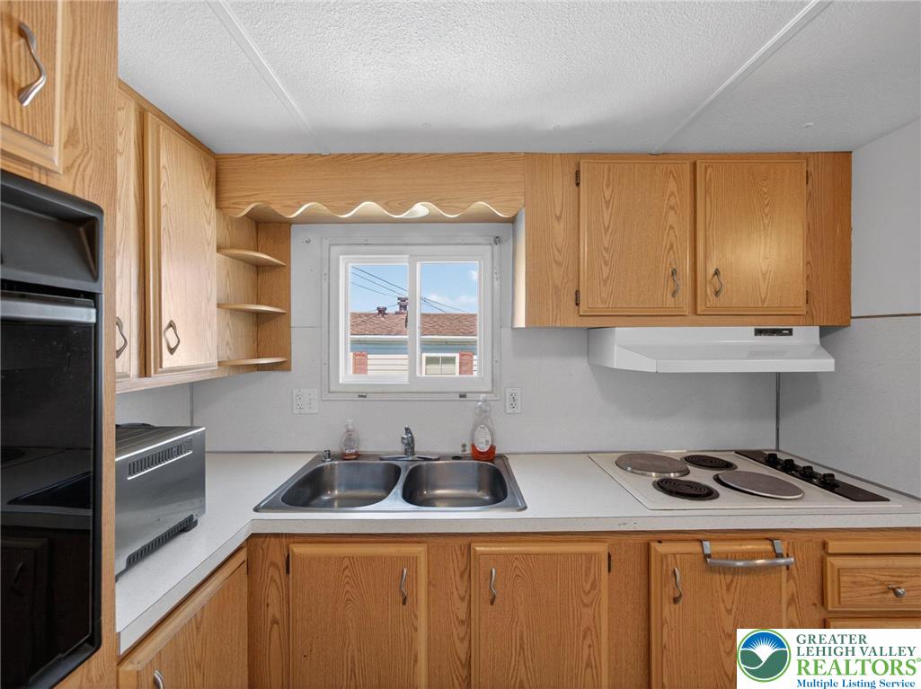 23 Roth Avenue Mertztown, PA 19539 - Photo 15 of 29 a kitchen with a sink a stove and cabinets