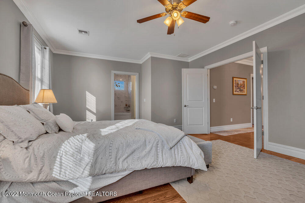 612 Lake Avenue Spring Lake Heights, NJ 07762 - Photo 11 of 22 a bedroom with a bed and a chandelier