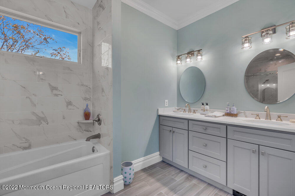 612 Lake Avenue Spring Lake Heights, NJ 07762 - Photo 12 of 22 a bathroom with a double vanity sink mirror and bathtub