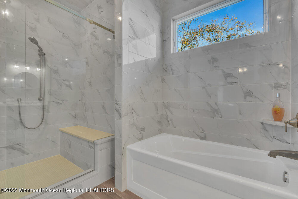 612 Lake Avenue Spring Lake Heights, NJ 07762 - Photo 13 of 22 a bathroom with a bath tub a glass door shower and a sink