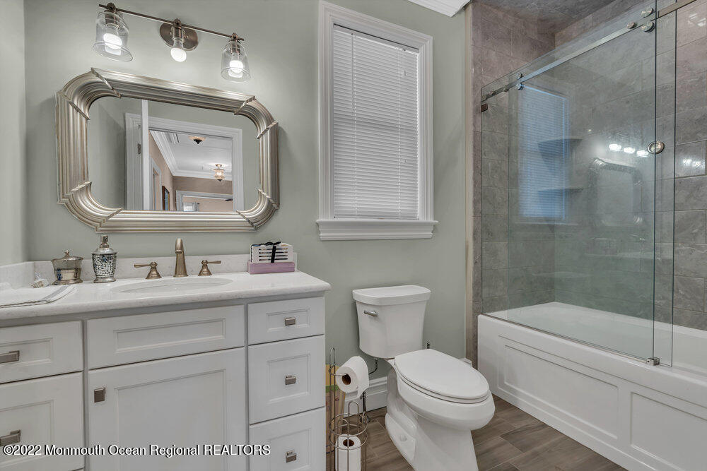 612 Lake Avenue Spring Lake Heights, NJ 07762 - Photo 17 of 22 a bathroom with a toilet sink and mirror